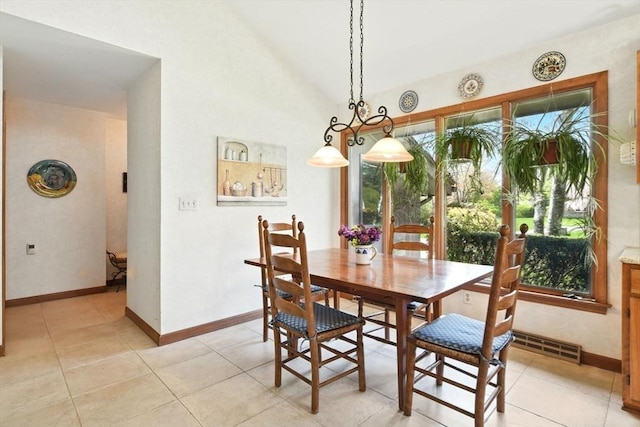 dining space with baseboards, light tile patterned floors, and lofted ceiling