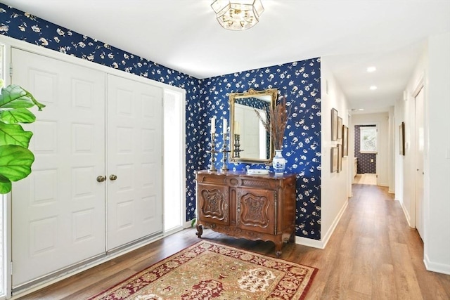 foyer featuring baseboards, recessed lighting, wood finished floors, and wallpapered walls