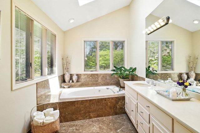 bathroom with a bath, plenty of natural light, lofted ceiling, and vanity