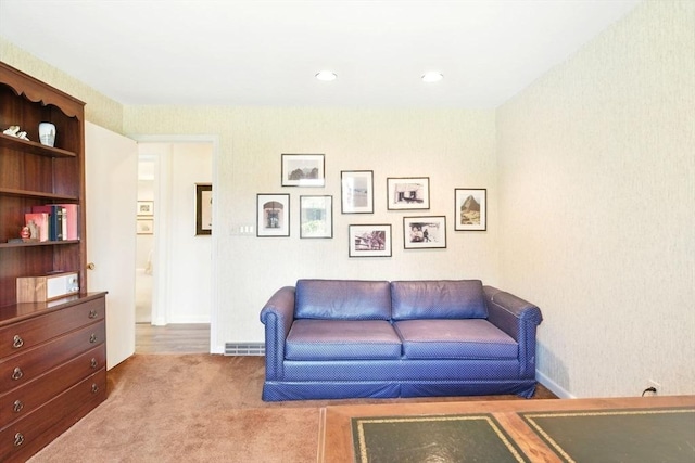 carpeted living area with recessed lighting and baseboards