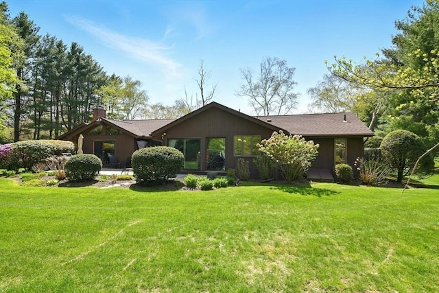 view of front of house with a front lawn and a chimney