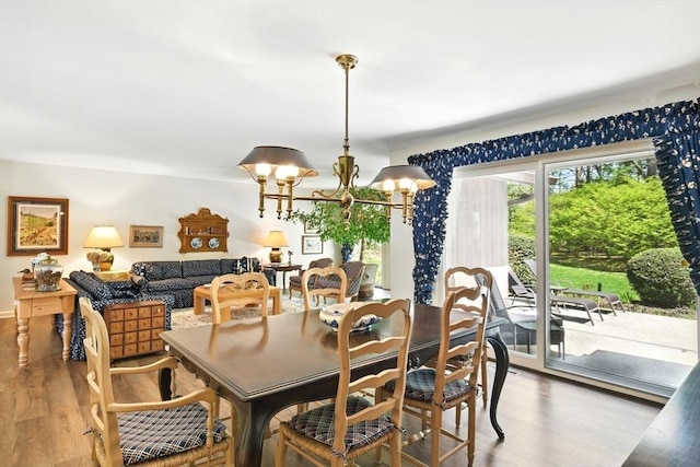 dining room with an inviting chandelier and wood finished floors