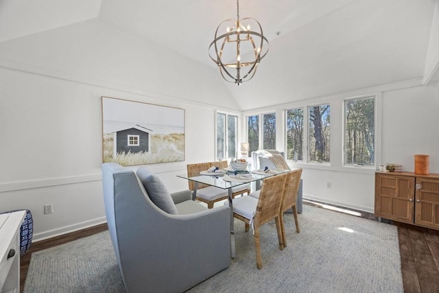 dining room with dark wood-type flooring, lofted ceiling, a notable chandelier, and baseboards