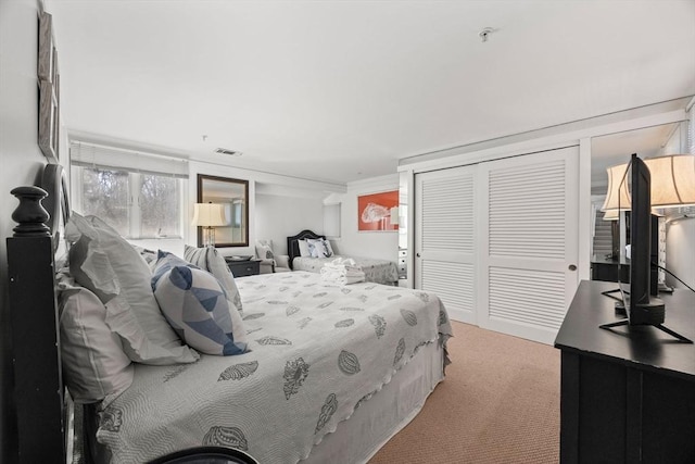 bedroom with carpet, a closet, and visible vents