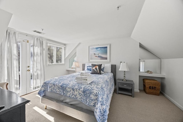 bedroom featuring access to exterior, light colored carpet, vaulted ceiling, and baseboards