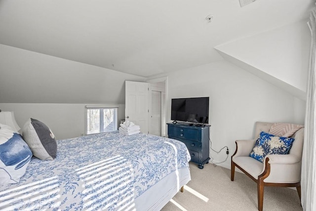 bedroom featuring light carpet and vaulted ceiling