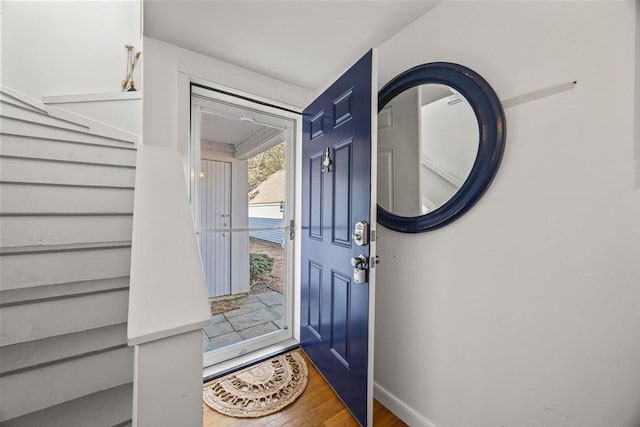 foyer featuring baseboards and wood finished floors