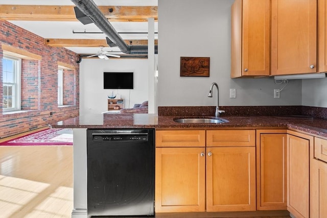 kitchen with dishwasher, kitchen peninsula, sink, dark stone counters, and brick wall