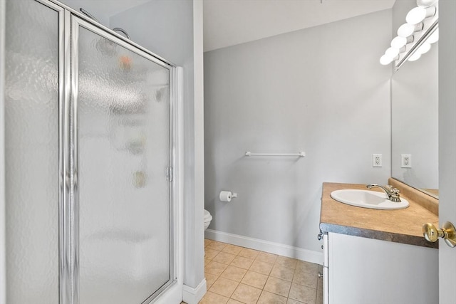 bathroom with toilet, tile patterned flooring, a shower with shower door, and vanity