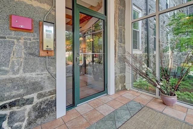 doorway to outside featuring tile patterned floors