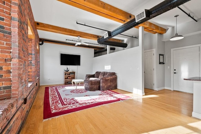 living room with ceiling fan and hardwood / wood-style flooring