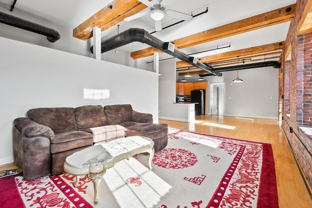 living room featuring light hardwood / wood-style floors, beam ceiling, and ceiling fan