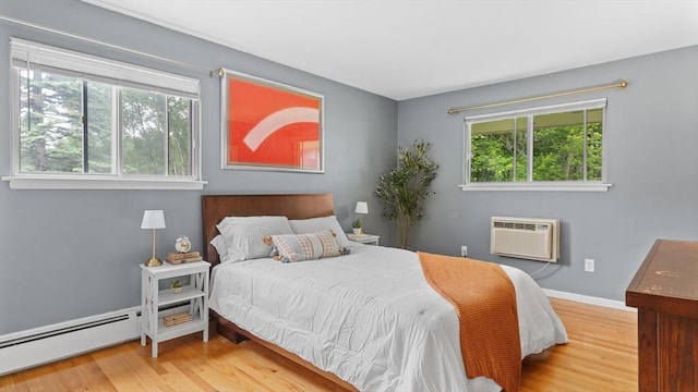 9 Longwood Dr Unit 11, Andover, MA 01810 - bedroom featuring an AC wall unit, multiple windows, and wood finished floors