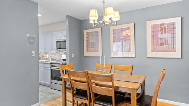 9 Longwood Dr Unit 11, Andover, MA 01810 - dining area featuring light wood-style floors and a chandelier
