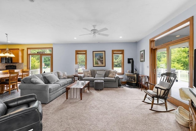 45 Pleasant St, Middleboro, MA 02346 - living room featuring a wood stove, healthy amount of natural light, carpet floors, a ceiling fan, and recessed lighting