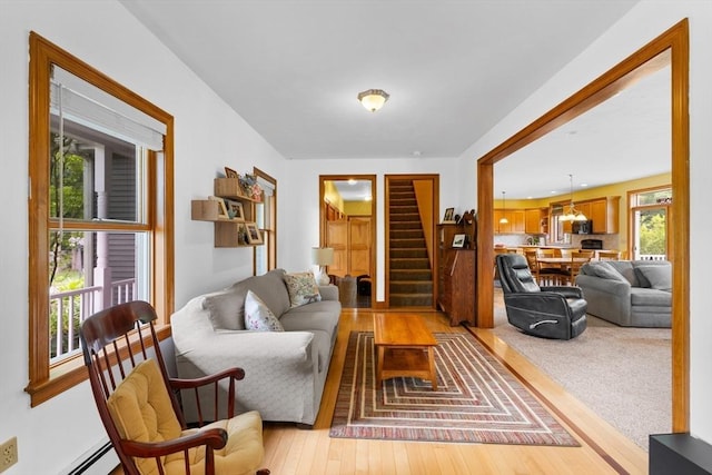 45 Pleasant St, Middleboro, MA 02346 - living area featuring baseboard heating, stairway, and light wood-type flooring