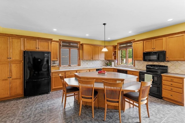 45 Pleasant St, Middleboro, MA 02346 - kitchen featuring black appliances, a center island, brown cabinets, light countertops, and recessed lighting