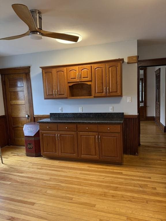 612 Grove St Lot 1, Worcester, MA 01605 - kitchen featuring light wood finished floors, a wainscoted wall, dark stone countertops, ceiling fan, and brown cabinets