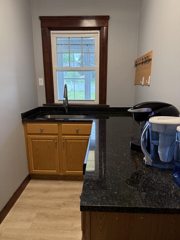 612 Grove St Lot 1, Worcester, MA 01605 - kitchen with a sink, dark stone countertops, baseboards, light wood-type flooring, and brown cabinets