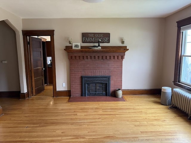 612 Grove St Lot 1, Worcester, MA 01605 - unfurnished living room with radiator, light wood-type flooring, baseboards, and a brick fireplace