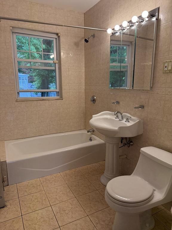 612 Grove St Lot 1, Worcester, MA 01605 - full bathroom featuring toilet, washtub / shower combination, tile patterned floors, and tile walls