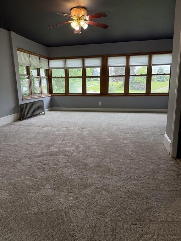 612 Grove St Lot 1, Worcester, MA 01605 - carpeted empty room featuring radiator, baseboards, and a ceiling fan