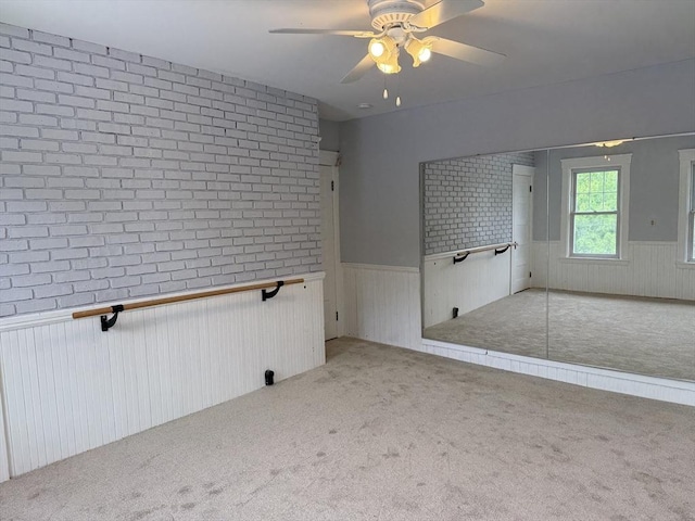 612 Grove St Lot 1, Worcester, MA 01605 - empty room with a wainscoted wall, carpet floors, ceiling fan, and brick wall