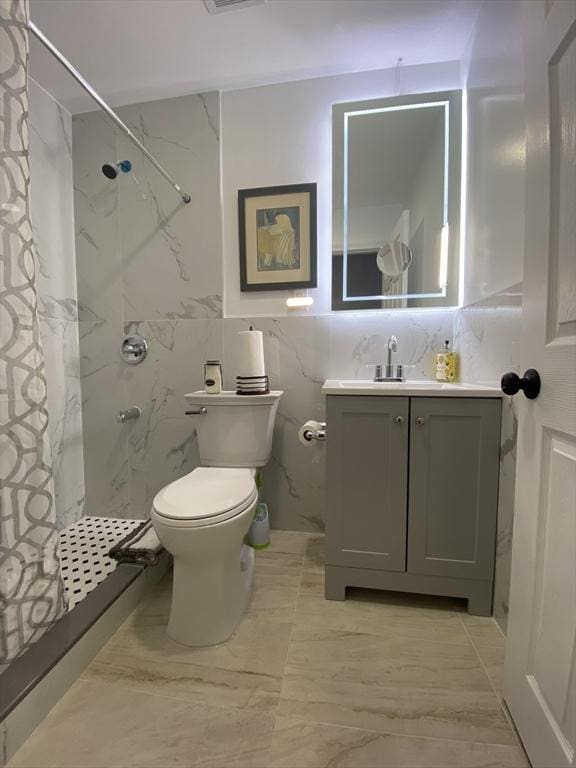 612 Grove St Lot 1, Worcester, MA 01605 - bathroom featuring vanity, a marble finish shower, toilet, tile walls, and marble finish floors