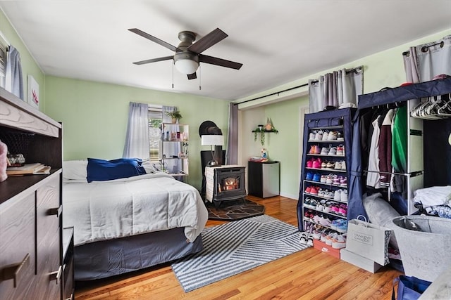96 Hurd St, Lynn, MA 01905 - bedroom with a wood stove, wood finished floors, a ceiling fan, and refrigerator