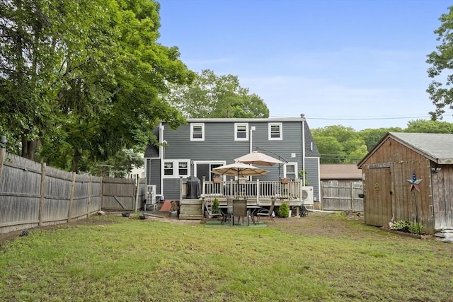 96 Hurd St, Lynn, MA 01905 - back of property featuring a wooden deck, a storage shed, and a fenced backyard