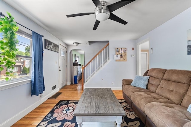 96 Hurd St, Lynn, MA 01905 - living room featuring stairs, arched walkways, light wood finished floors, and a ceiling fan