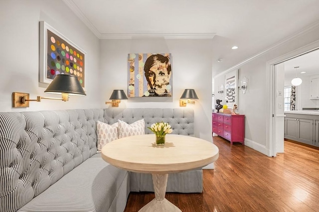 sitting room featuring recessed lighting, crown molding, baseboards, and wood finished floors