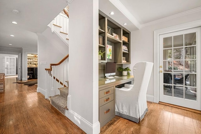 home office featuring baseboards, ornamental molding, hardwood / wood-style floors, built in desk, and recessed lighting