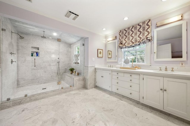 bathroom featuring visible vents, double vanity, a stall shower, ornamental molding, and a sink