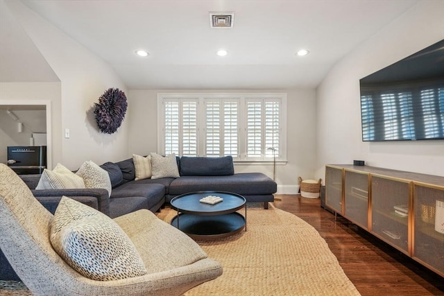 living area with recessed lighting, baseboards, dark wood finished floors, and vaulted ceiling