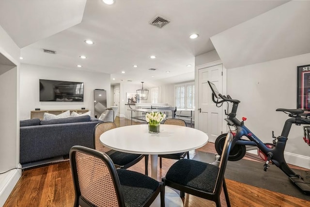 dining space with recessed lighting, wood finished floors, and visible vents