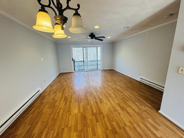 empty room featuring light wood-type flooring, a baseboard heating unit, ornamental molding, and ceiling fan