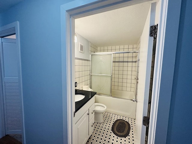 bathroom featuring vanity, visible vents, a textured ceiling, tile patterned floors, and toilet