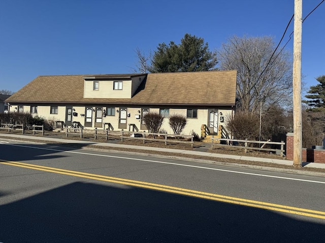 view of property featuring a fenced front yard and entry steps