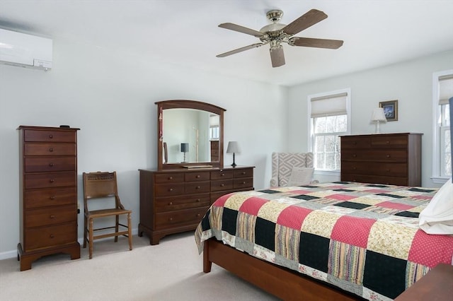 carpeted bedroom featuring a ceiling fan and a wall mounted air conditioner