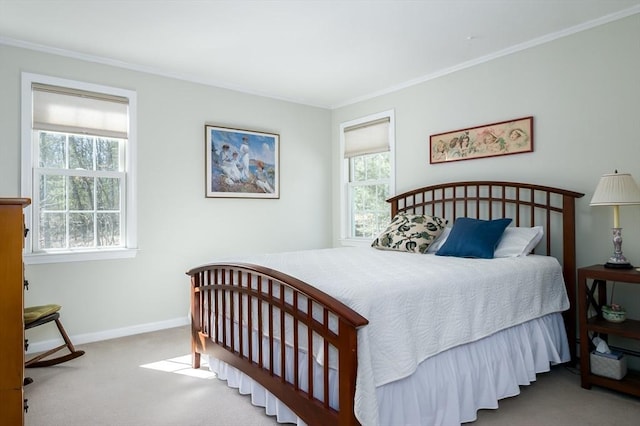 carpeted bedroom featuring baseboards and crown molding