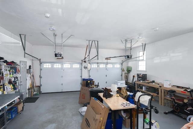 garage with a workshop area and a garage door opener