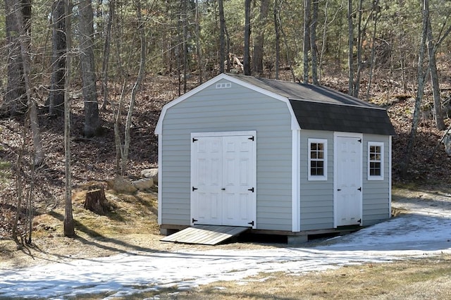 view of shed featuring a view of trees