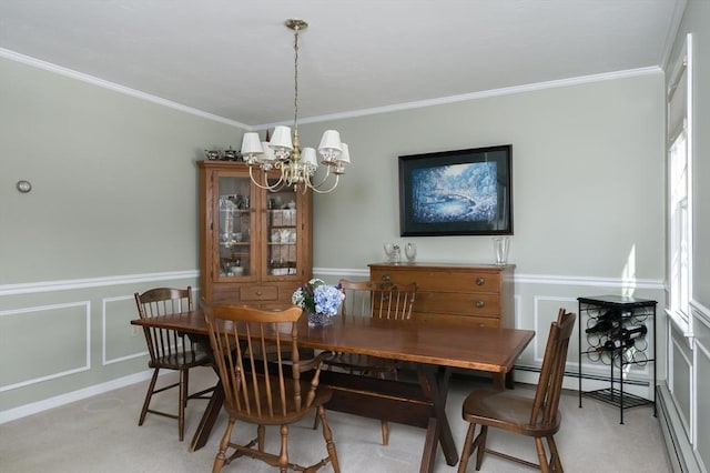 dining room featuring a chandelier, crown molding, and light colored carpet