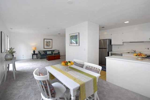 dining space with light colored carpet