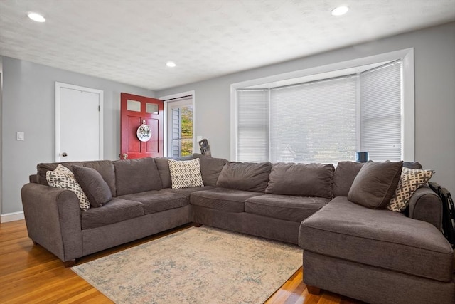 living room featuring light wood-type flooring, recessed lighting, and baseboards