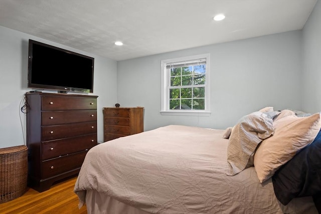 bedroom with wood finished floors and recessed lighting