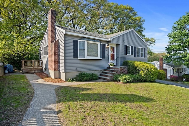 view of front of property with a chimney and a front yard