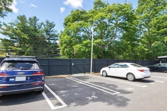 280 Boylston St Unit 110, Newton, MA 02467 - uncovered parking lot featuring a gate