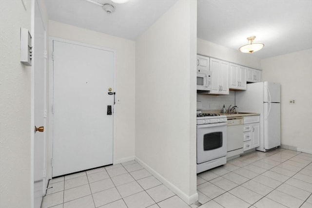 280 Boylston St Unit 110, Newton, MA 02467 - kitchen featuring white appliances, white cabinets, light tile patterned floors, and decorative backsplash